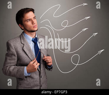 Attractive man looking at multiple curly arrows Stock Photo