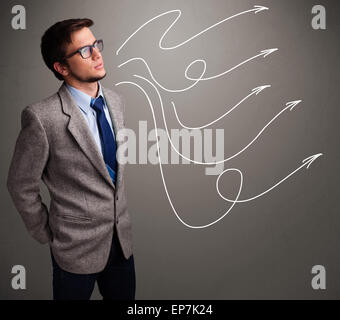 Attractive man looking at multiple curly arrows Stock Photo