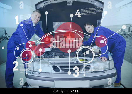 Two happy mechanics consulting futuristic interface with open hood Stock Photo