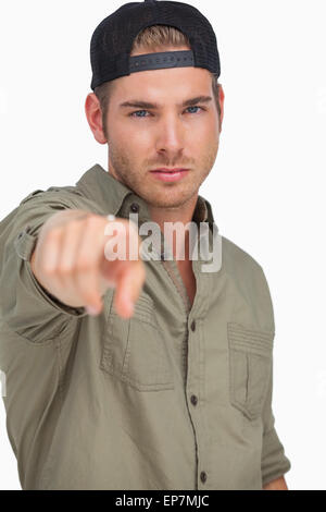 Man wearing baseball hat backwards and pointing Stock Photo - Alamy