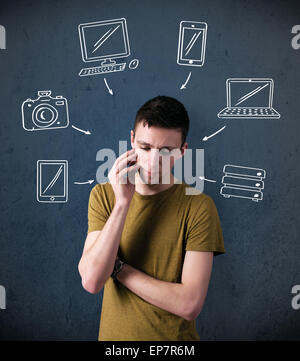 Young man thinking with drawn gadgets around his head Stock Photo
