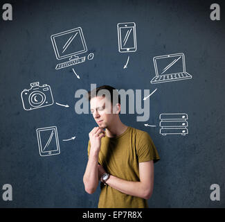 Young man thinking with drawn gadgets around his head Stock Photo