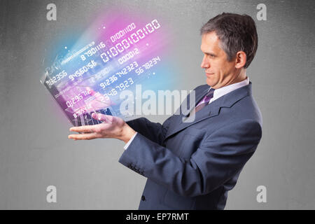 Businessman holding notebook with exploding data and numbers Stock Photo