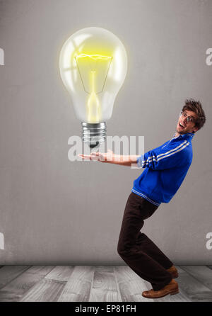 Attractive man holding realistic 3d light bulb Stock Photo