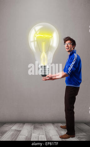 Attractive man holding realistic 3d light bulb Stock Photo