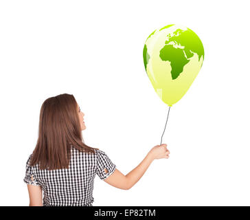 Happy lady holding a green globe balloon Stock Photo