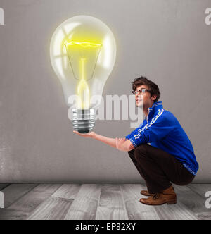 Attractive man holding realistic 3d light bulb Stock Photo