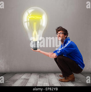 Attractive man holding realistic 3d light bulb Stock Photo