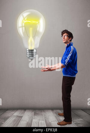 Attractive man holding realistic 3d light bulb Stock Photo