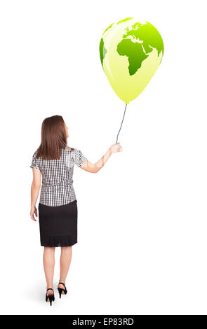 Happy lady holding a green globe balloon Stock Photo