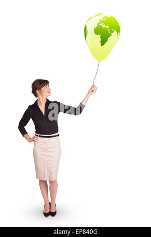 Happy lady holding a green globe balloon Stock Photo