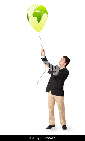 handsome man holding a green globe balloon Stock Photo