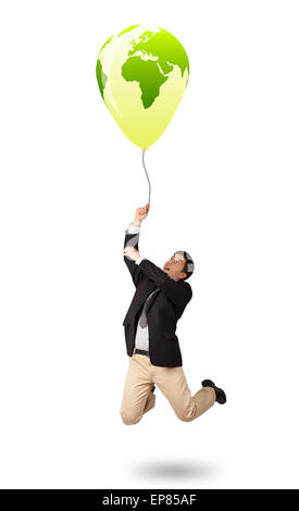 handsome man holding a green globe balloon Stock Photo