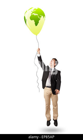 handsome man holding a green globe balloon Stock Photo