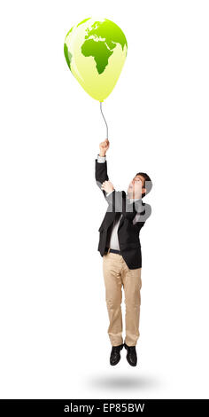 handsome man holding a green globe balloon Stock Photo