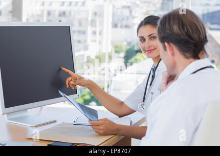 Doctor showing the screen of a computer to a colleague Stock Photo