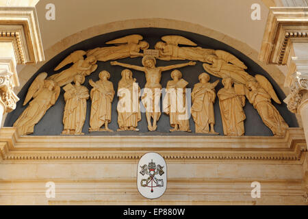 Crucifixion scene above the portal of the Basilica church of Santi Medici in Alberobello, Apulia, Italy. Stock Photo