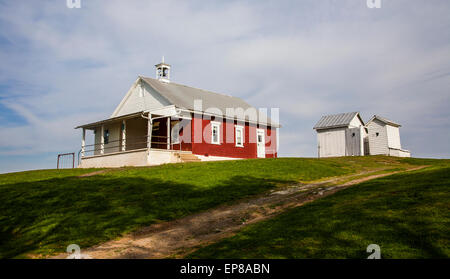 Historic red brick Amish one room schoolhouse exterior and outhouses in Lancaster County, PA, USA, Pennsylvania, US, American Schools old school house Stock Photo