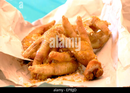 walkie talkies or chicken feet are a common south african street food they are chicken feet often served with pap and curried stew or deep fried Stock Photo