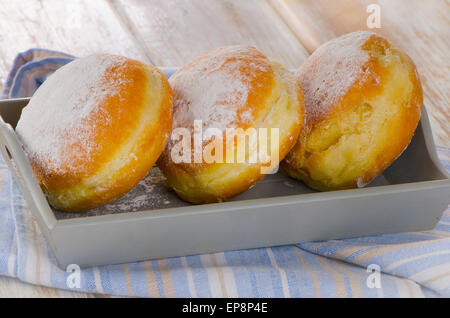 Homemade Donuts with powdered sugar in  a wooden box. Selective focus Stock Photo