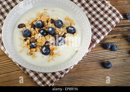 Healthy breakfast - yogurt with blueberries and muesli served in  bowl. Stock Photo