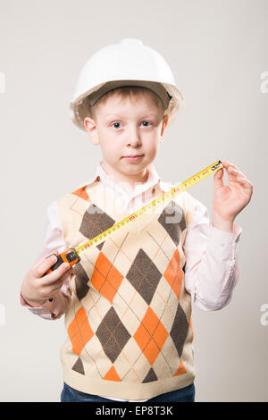 Boy in a white construction helmet Stock Photo
