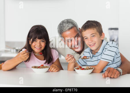 Happy father talking with his children during their breakfast Stock Photo
