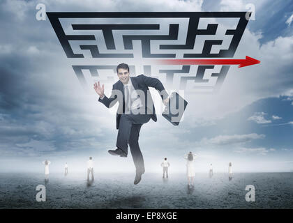 Businessman leaping happily in front of giant qr code Stock Photo