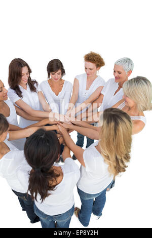 Happy female models joining hands in a circle Stock Photo