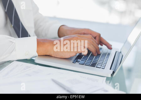 Close up on businessmans hands typing on his laptop Stock Photo