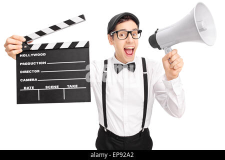 Young movie director with a black beret holding a clapperboard and speaking on a megaphone isolated on white background Stock Photo