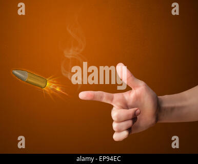 Gun shaped male hand with bullet Stock Photo