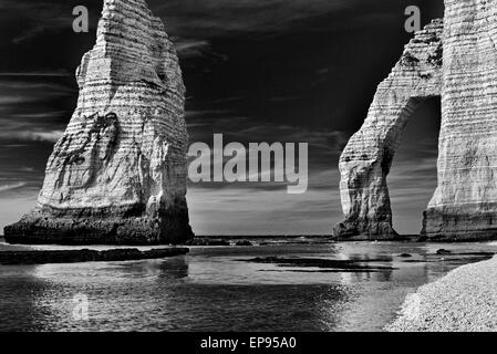 France, Normandy: Rock formations at beach in Étretat as black and white version Stock Photo