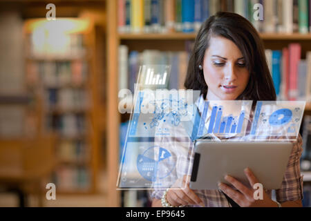 Pretty student working on her futuristic tablet Stock Photo