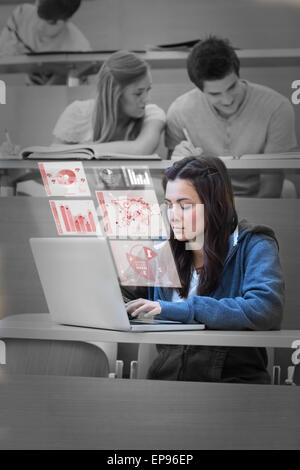 Pretty brunette studying on her futuristic laptop Stock Photo