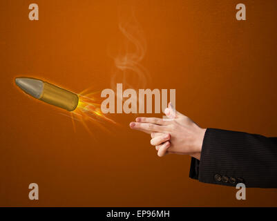 Gun shaped male hand with bullet Stock Photo