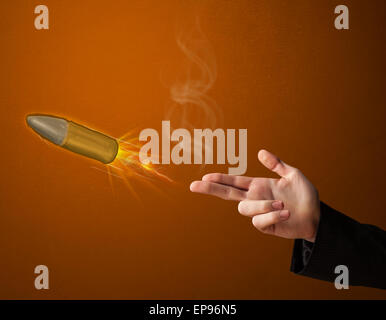 Gun shaped male hand with bullet Stock Photo