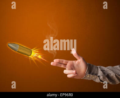 Gun shaped male hand with bullet Stock Photo