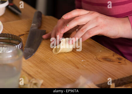 Making Pasta and Tortellini at Home on Wooden Rack and Chrome Pasta Maker  Stock Photo - Alamy