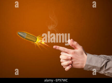 Gun shaped male hand with bullet Stock Photo