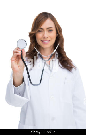 Smiling doctor holding stethoscope and looking at camera Stock Photo