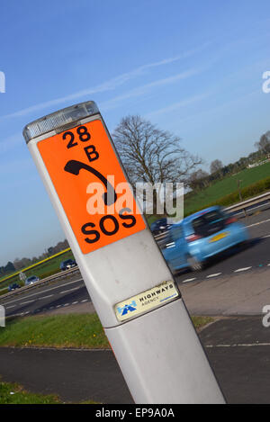 car passing sos emergency breakdown telephone on the a64 road near york yorkshire uk Stock Photo