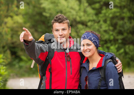 Smiling couple going on a hike together looking ahead Stock Photo