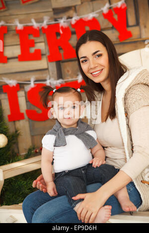 Happy smiling mother with daughter. Christmas time Stock Photo