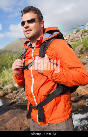 Man wearing rain jacket and sunglasses smiling Stock Photo