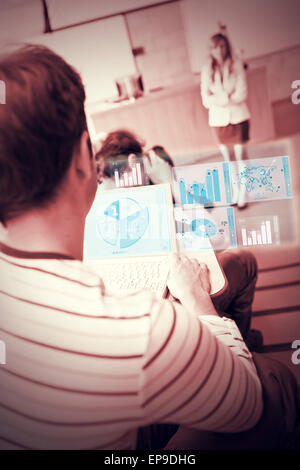 Focused student analysing graphs on his futuristic notebook Stock Photo