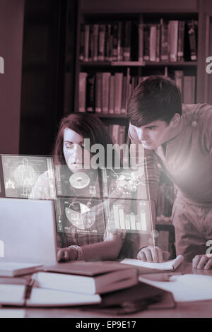 Focused students analysing graphs on their digital interface Stock Photo