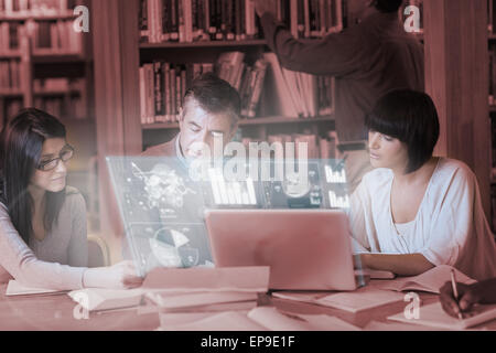 Focused mature students working together on digital interface Stock Photo