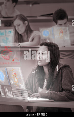 Focused pretty student working on her futuristic laptop Stock Photo