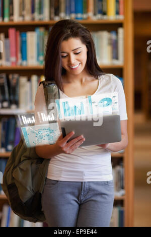 Happy pretty student working on her futuristic tablet Stock Photo